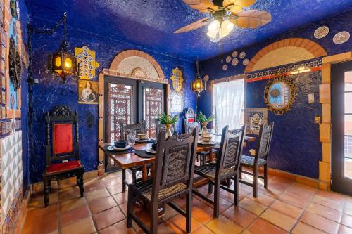 a dining room with blue walls and a table and chairs at The Gaudi House- Pool Minutes to DNTN and Beach in St. Augustine