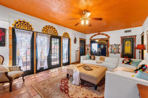 a living room with a couch and a ceiling fan at The Gaudi House- Pool Minutes to DNTN and Beach in St. Augustine