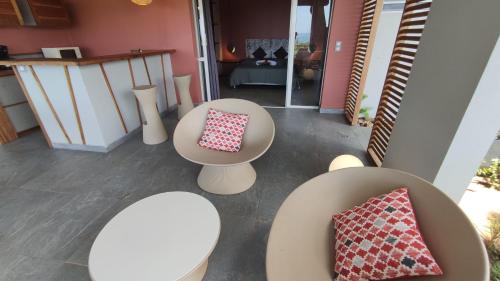 an overhead view of tables and chairs in a room at Hotel - Résidence Habitation Grande Anse in Deshaies