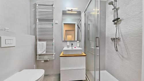 a white bathroom with a sink and a shower at Good Vibes in Zagreb