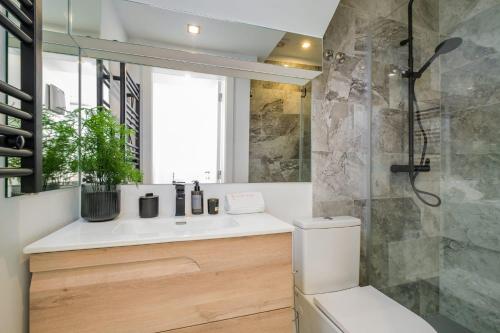 a bathroom with a toilet and a sink and a shower at Bela Vista in Cascais