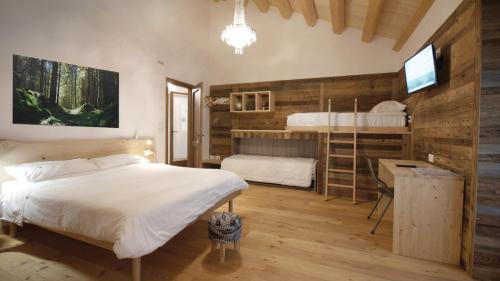 1 Schlafzimmer mit 2 Etagenbetten und einem TV in der Unterkunft Agribed Quierta - Camere Matrimoniali 
