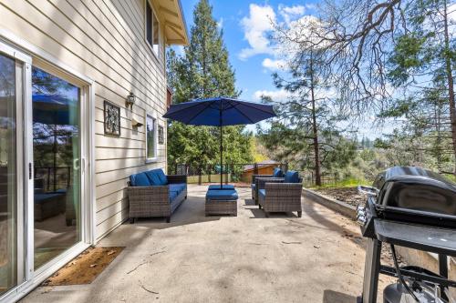 a patio with two chairs and an umbrella at Big Creek Hideaway in Groveland