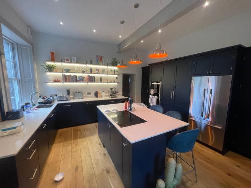a kitchen with a sink and a refrigerator at Large 3 double bedroom period house with parking in Edinburgh