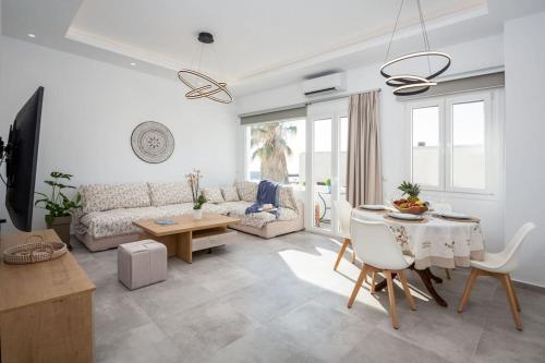 a living room with a couch and a table at Naxian sun apartment in Naxos Chora