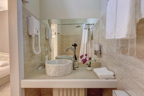 a bathroom with a sink and a shower at Well Sleep Hotel in Almaty