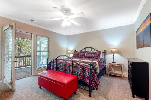 a bedroom with a bed and a ceiling fan at Riverside Trout Cottage in Helen