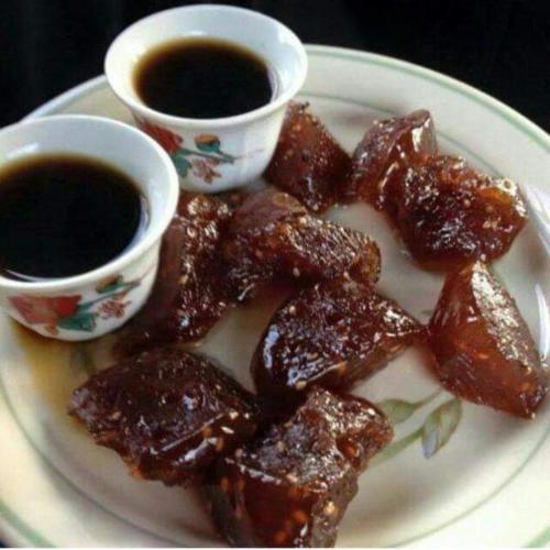 a plate of food with two cups of sauce at Mombasa Comfort House, Old Town in Mombasa