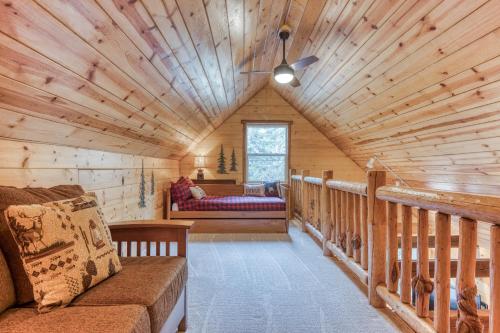 a log cabin living room with a couch and a window at John Lake Lodge in Rhododendron