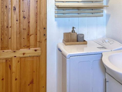 a bathroom with a washing machine and a sink at Holiday home Hovborg XI in Hovborg