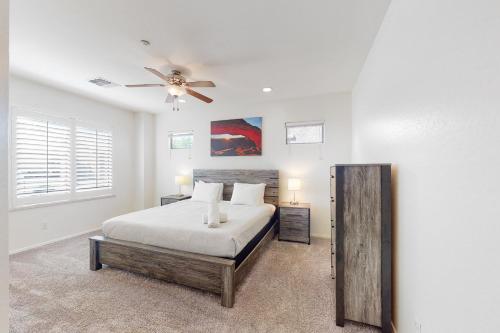 a bedroom with a bed and a ceiling fan at Peoria Magic in Peoria