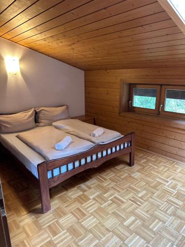 a bedroom with a bed in a wooden cabin at Haus Wenger Mountain View & Swimming Pool in Kaprun