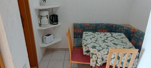 a small kitchen with a table and a coffee maker at MIRKO DIVING CENTER in Rab