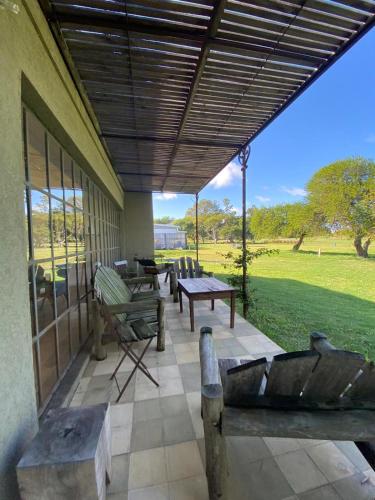 a patio with benches and tables on a building at Casa en Carmelo Golf Club in Carmelo