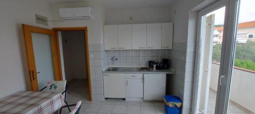 a small kitchen with a sink and a window at MIRKO DIVING CENTER in Rab