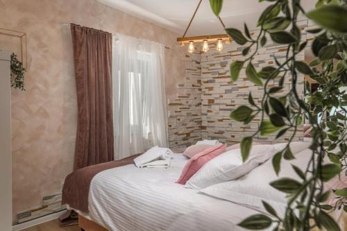 a bedroom with a bed and a brick wall at Piccola Villa Adriatic with a swimming pool, grill, children playground Opatija in Ičići