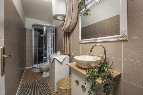 a bathroom with a sink and a toilet at Piccola Villa Adriatic with a swimming pool, grill, children playground Opatija in Ičići