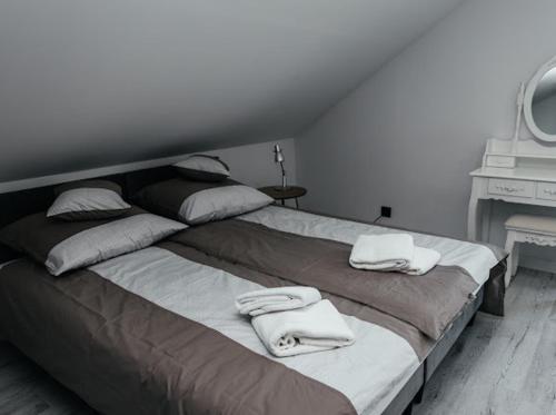sypialnia z dużym łóżkiem z ręcznikami w obiekcie Korcza w Inwałdzie