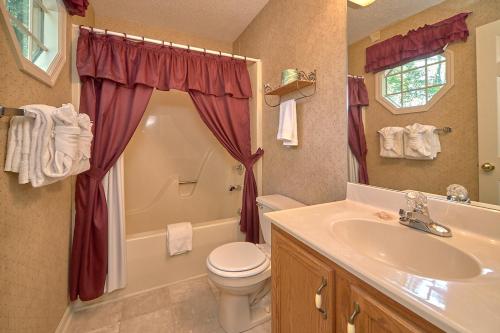 a bathroom with a sink and a toilet and a shower at Mountain Hideaway, 1 Bedroom, Sleeps 2, Wood Fireplace, WiFi, Pool Table in Gatlinburg
