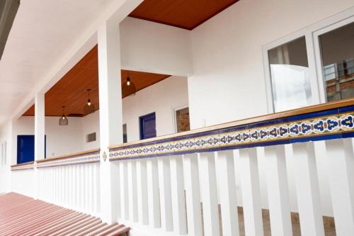 a white house with blue and white railing at CASONA DON LUCAS in Tarapoto