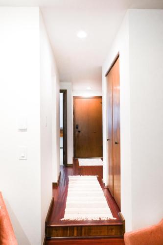 a hallway with a door and a rug on the floor at Summit Suite in Glacier
