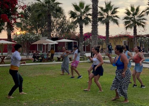 a group of people playing frisbee in a park at La Estancia Chincha Hotel in Chincha Alta