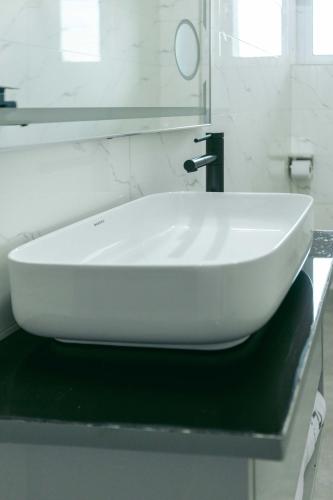 a white sink on a counter in a bathroom at Phoenix Luxury Apartments in Abuja