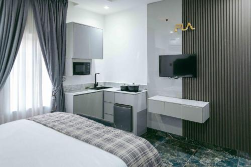 a hotel room with a bed and a tv at Phoenix Luxury Apartments in Abuja