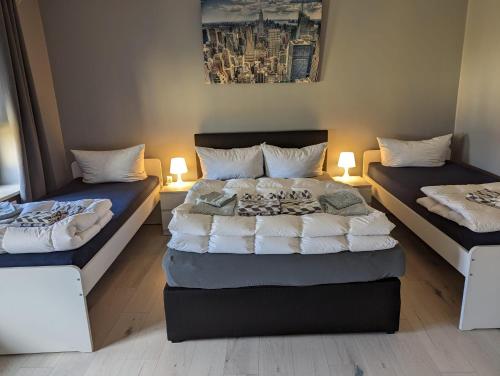 a bedroom with two beds and two lamps in it at Flensburg Zentrum 69 02 in Flensburg