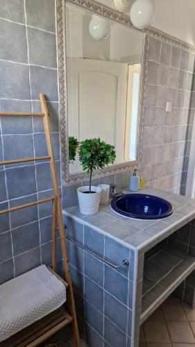 a bathroom with a blue sink and a mirror at Beachfront house,Manta Rota,Algarve in Vila Nova De Cacela