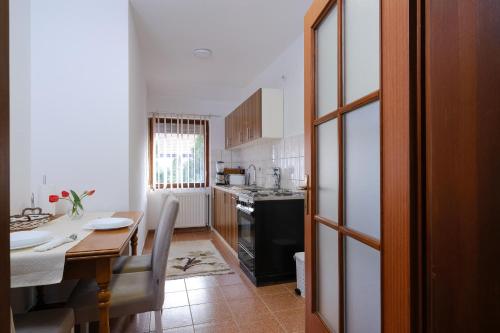 a kitchen with a table and a dining room at The Cosmic Gate Apartments in Visoko