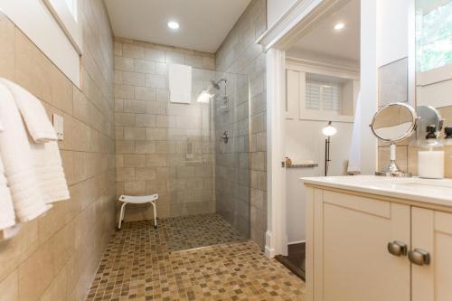 a bathroom with a shower and a sink at Beacon Hill in Carriage House at Oak Street Mansion in Kansas City