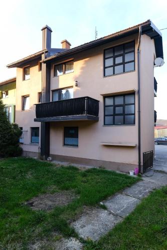 a house with a balcony on the side of it at The Cosmic Gate Apartments in Visoko