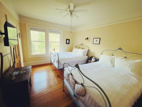 a bedroom with two beds and a window at Sasquatch Crossing Eco Lodge B&B in Harrison Mills