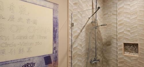 a bathroom with a shower with a sign on the wall at Magic Village 4 Bedroom! Welcome Home! in Orlando