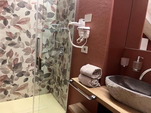 a bathroom with a sink and a shower at Le Rocce Val di Non - Quality Room & Breakfast in Tassullo