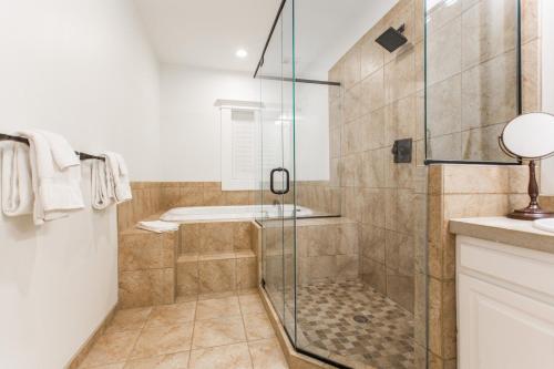 a bathroom with a shower with a tub at Southmoreland at Oak Street Mansion in Kansas City