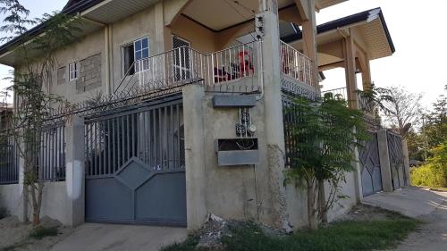 a house with a blue door and a balcony at JZA Transient House in Cagayan de Oro