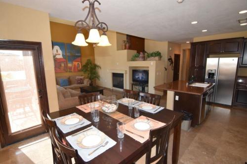 a kitchen and living room with a table and chairs at Super close to the beach house for rent in San Felipe - FREE WiFi + Golf Pass in La Ponderosa