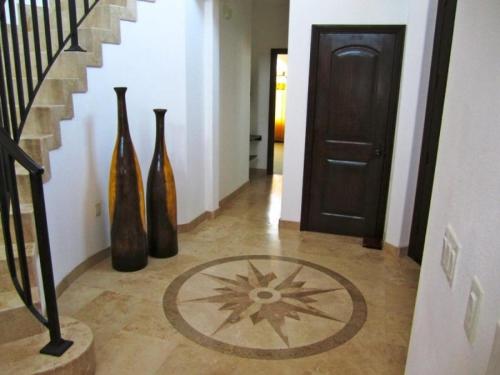 a hallway with three vases sitting next to a staircase at San Felipe Ultra Deluxe Elegance with Spectacular Sea Views in Playa El Paraíso