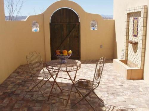 a patio with a table and chairs in front of a building at El Dorado Ranch San Felipe Rental Home W/ In Home WiFi in Playa Unión