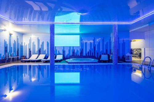 a swimming pool with a city skyline in the background at Plaza House Ílhavo in Ílhavo