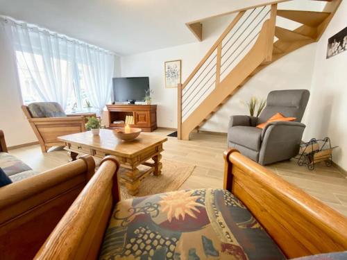 a living room with a couch and a table at Le Familik- Maison- CentreVille in Licques