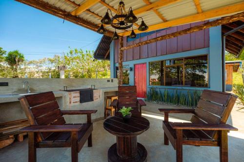 a patio with chairs and a table and a fireplace at The Red Door Mountain Cabin in Guadalupe