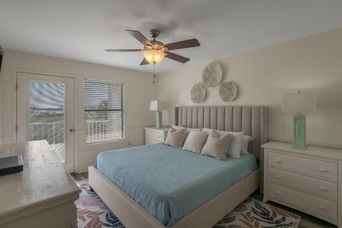 a bedroom with a bed and a ceiling fan at Jubilee Landing 110 by Vacation Homes Collection in Orange Beach