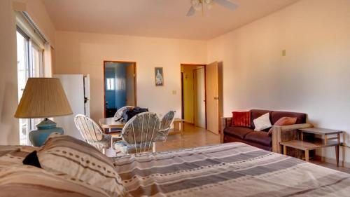 a bedroom with a bed and a living room at El Dorado Ranch Rental - Judy`s Casita in San Felipe