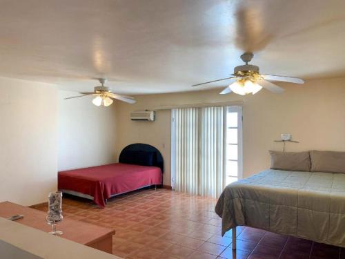 a bedroom with a bed and two fans at El Dorado Ranch San Felipe - Casa Rocky Point Vacation Rental with Private Pool in San Felipe