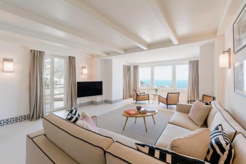 a living room with a couch and a tv at Palazzo M Capri in Capri