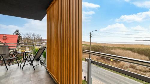 a view of the ocean from the balcony of a house at BURSZTYNOVA Apartamenty Piamola in Kąty Rybackie