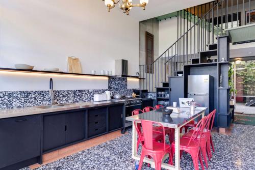 a kitchen with a table and red chairs at City Apartment NEW 3Bed Highgate Hill in Brisbane